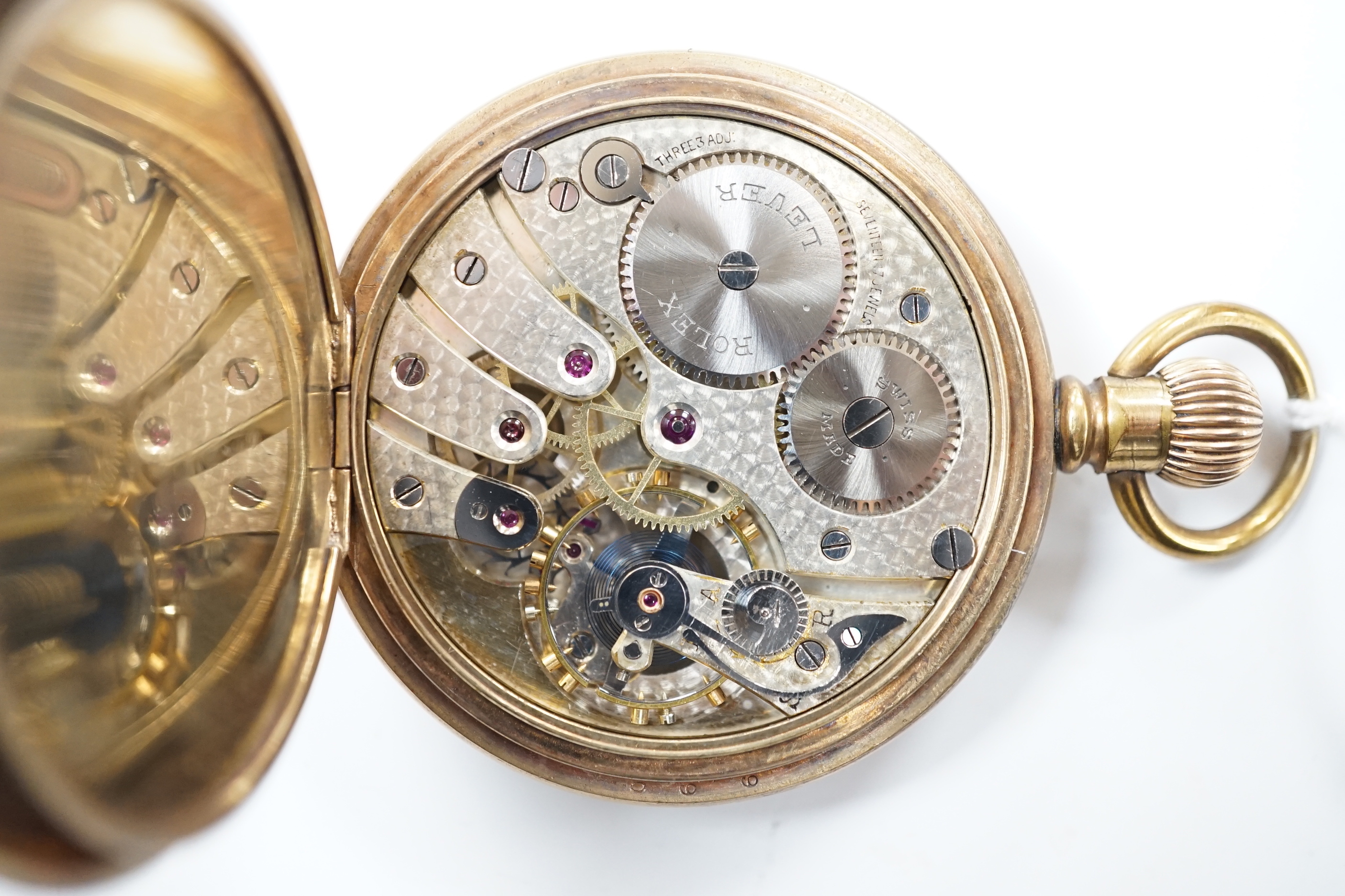 A gold plated Rolex open face keyless pocket watch, with black dial and white Arabic numerals, case diameter 50mm.